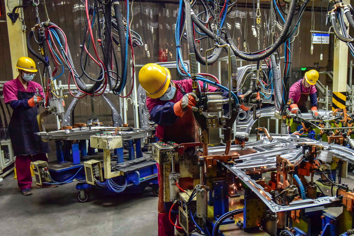 <i>STR/AFP/Getty Images</i><br/>Workers assemble vehicles at a factory in Qingzhou