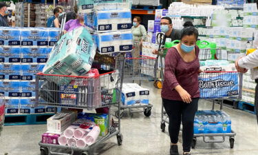 People buy toilet papers and paper towels at a Costco Wholesale store as panic buying following the coronavirus disease outbreak in Alhambra