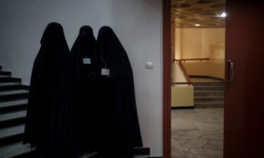 Women will no longer be allowed to attend classes or work at Kabul University for now. Women in an auditorium at Kabul University are pictured here during a demonstration in support of the Taliban on September 11.