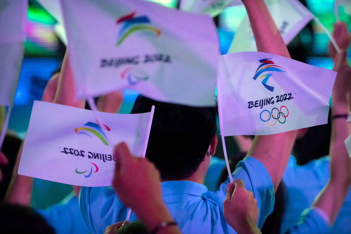 <i>Mark Schiefelbein/AP</i><br/>The Beijing 2022 Winter Olympics will be open to spectators -- but only if they live in mainland China. Participants here wave flags with the logos of 2022 Beijing Winter Olympics and Paralympics in Beijing