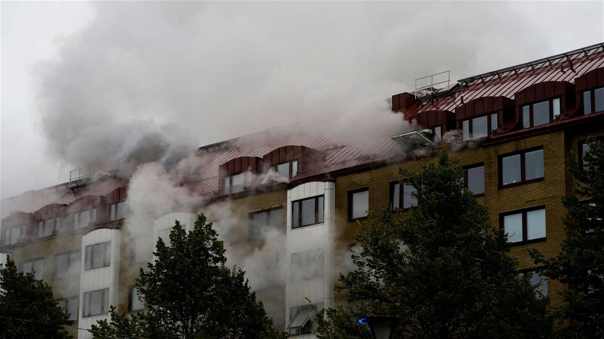<i>Bjorn Larsson Rosvall/TT News Agency/AFP via Getty Images</i><br/>Smoke billows from a building as emergency services fight a fire caused by an explosion in central Gothenburg.