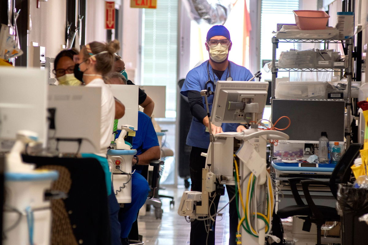 <i>Scott Rogers/The Times/AP</i><br/>Northeast Georgia Medical Center critical care staff work with Covid-19 patients on Monday