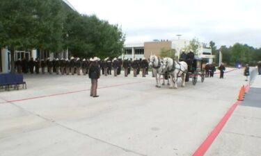 Officers line up in front of a Houston funeral home on October 25 to honor Kareem Atkins