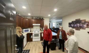 Tina Amble (left) shows off her new apartment that is in a former second-grade classroom of a building that from 1968 to 2018 was home to Arena Elementary School.