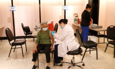 A Safeway pharmacist prepares to give a Pfizer Covid-19 booster shot in San Rafael