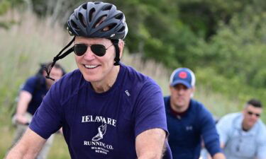 US President Joe Biden rides his bicycle in Cape Henlopen State Park on June 3