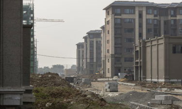 Embattled conglomerate Evergrande and other developers have warned they could default on their huge debts. Pictured is an unfinished apartment building in Nanjing