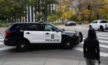 A police vehicle travels in downtown Minneapolis on Sunday