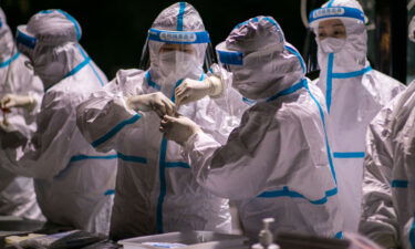 Authorities in northern China are reimposing lockdowns and other emergency measures to curb the spread of coronavirus. Medical workers are shown here working on the samples of Covid-19 nucleic acid test at a testing site in Hohhot