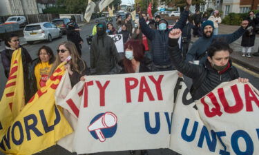 UK workers will be getting bigger paychecks starting in April following a hike to the minimum wage. Striking workers are seen here in London on October 21.