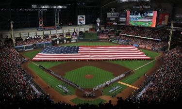 The Astros and Braves line up for the national anthem prior to the first pitch in Houston on October 26.