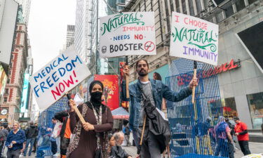 Public health groups worry threats to local officials could escalate as US plans vaccine rollout for kids. People protest on Times Square against vaccination mandates.