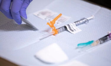 Medical assistant Norma Santana prepares a Moderna Covid-19 vaccine booster for Governor Kate Brown at Salem Health Edgewater Clinic in Salem