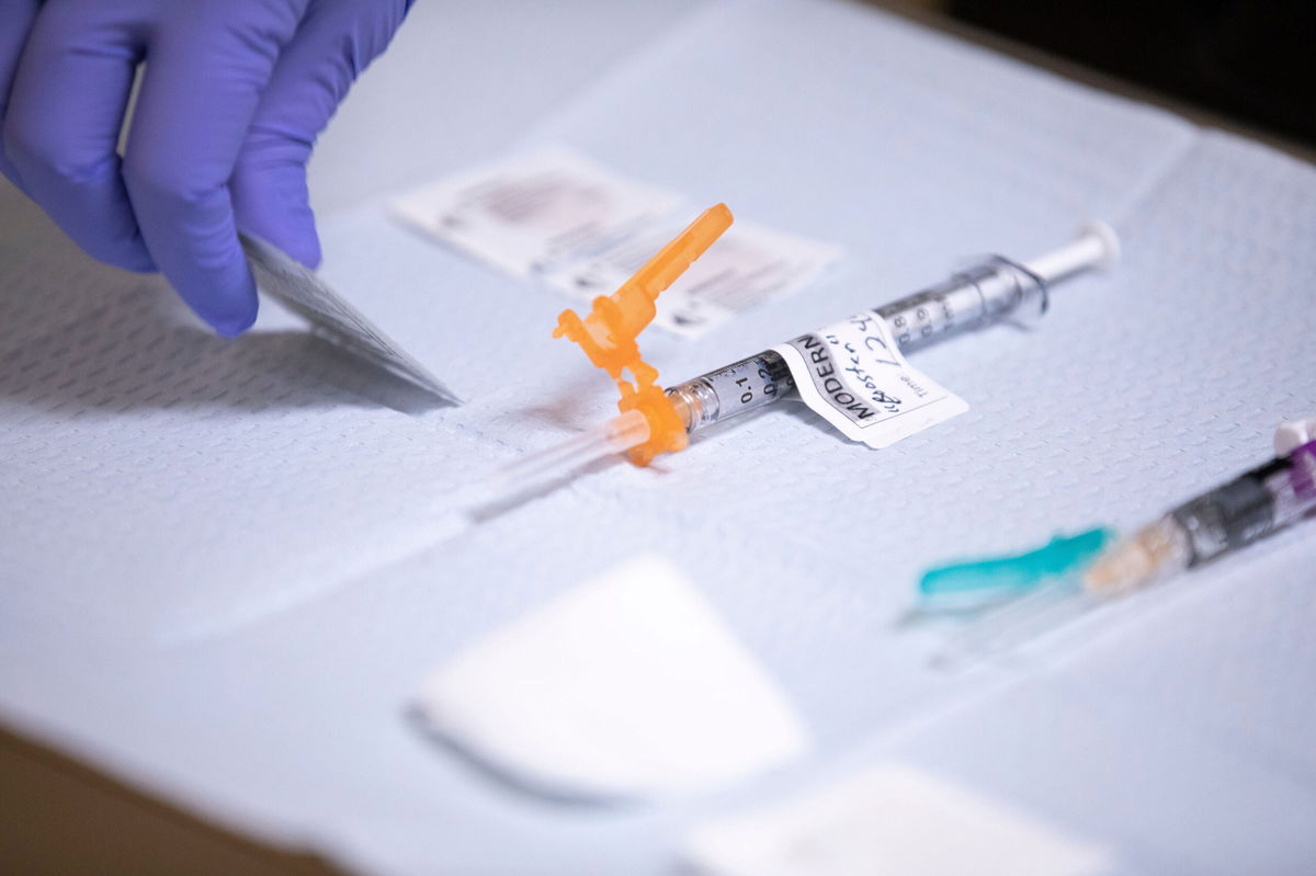 <i>Brian Hayes/Statesman Journal/USA Today Network</i><br/>Medical assistant Norma Santana prepares a Moderna Covid-19 vaccine booster for Governor Kate Brown at Salem Health Edgewater Clinic in Salem