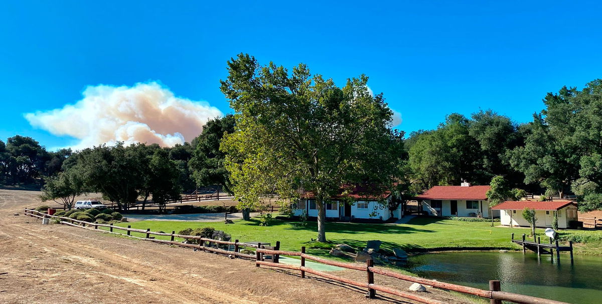 <i>Mike Eliason/Santa Barbara County Fire/AP</i><br/>A smoke column builds in the distance behind Rancho del Cielo in Santa Barbara County.