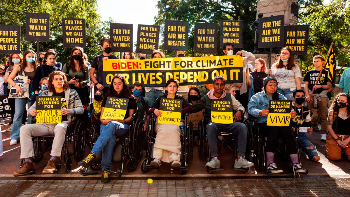 <i>Allison Bailey/NurPhoto via AP</i><br/>Demonstrators stand behind five young people on a hunger strike near the White House.