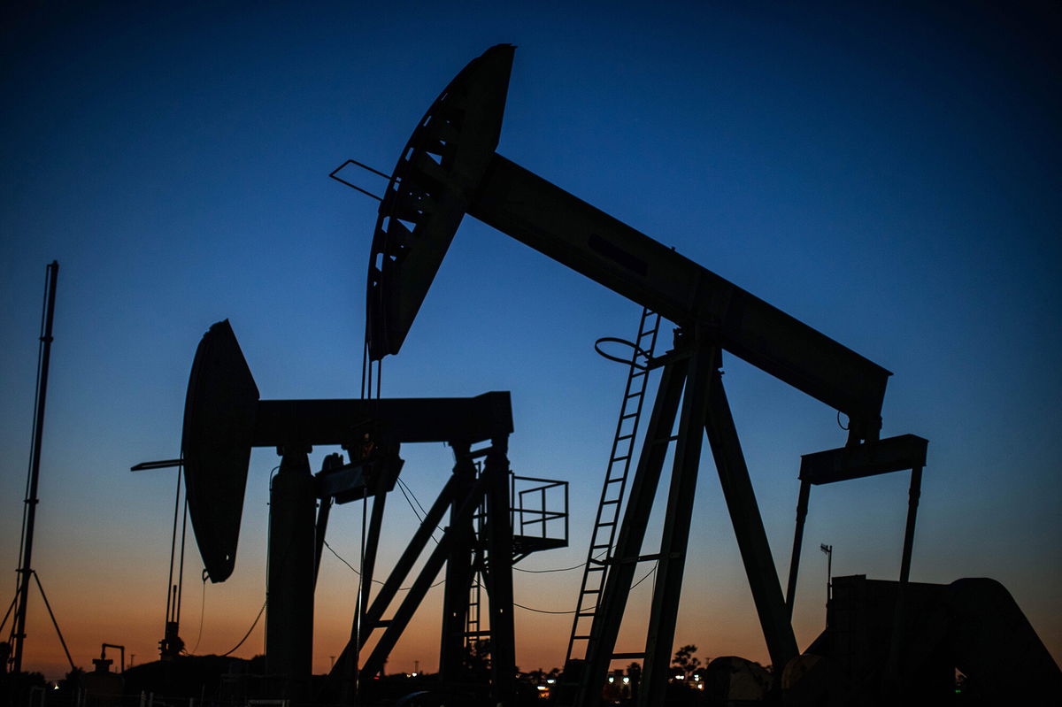 <i>Apu Gomes/AFP/Getty Images</i><br/>US oil jumped another 1.2% to trade as high as $85.07 a barrel. Oil pumpjacks are shown here operating at dusk Willow Springs Park in Long Beach