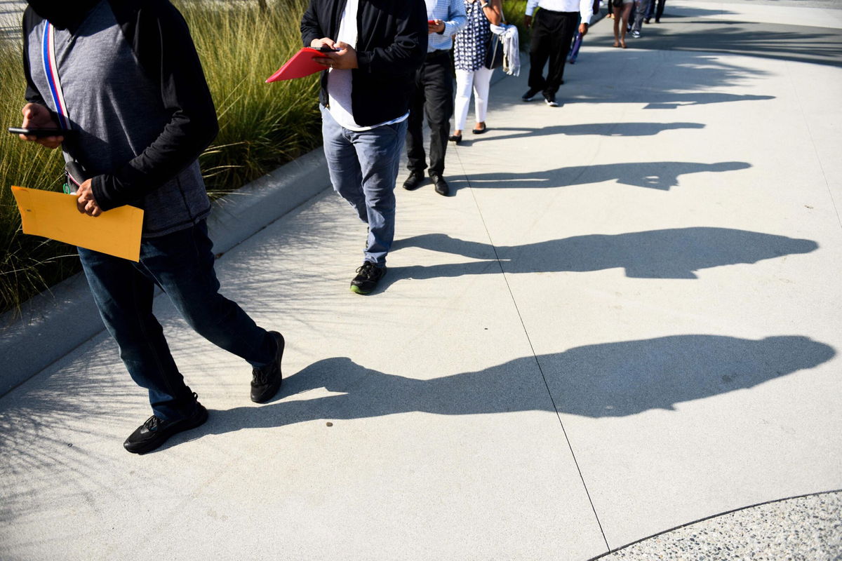 <i>Patrick T. Fallon/AFP/Getty Images</i><br/>Labor shortages are now a hallmark of the recovering pandemic economy. People are shown here lining up to attend a job fair for employment  at SoFi Stadium on September 9