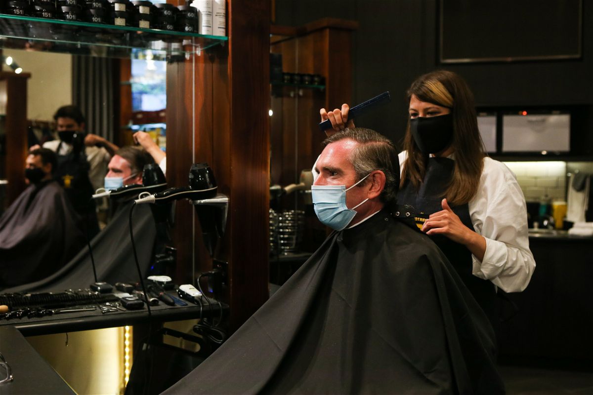 <i>Gaye Gerard/Pool/Getty Images</i><br/>NSW Premier Dominic Perrottet receives a haircut on October 11