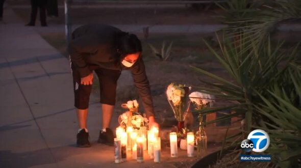 <i>KABC</i><br/>A woman adds to a growing memorial for Iran Moreno-Balvaneda