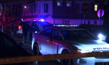 Police caution tape at a crime scene where a woman was shot in the head and stomach