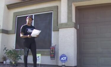 Nickole Langston reads the notice from her HOA after she put up a small garden flag that states 'Living Unapologetically Black.'