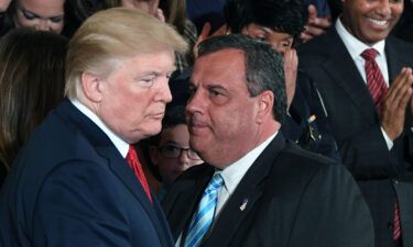 Governor Chris Christie(R-NJ) speaks with US President Donald Trump (L) on October 26