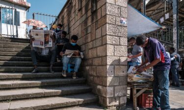 People read local newspapers in a downtown area of the city of Addis Ababa