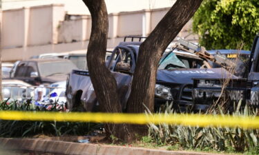 A general view shows wreckages of police vehicles at the scene of a blast in Kampala