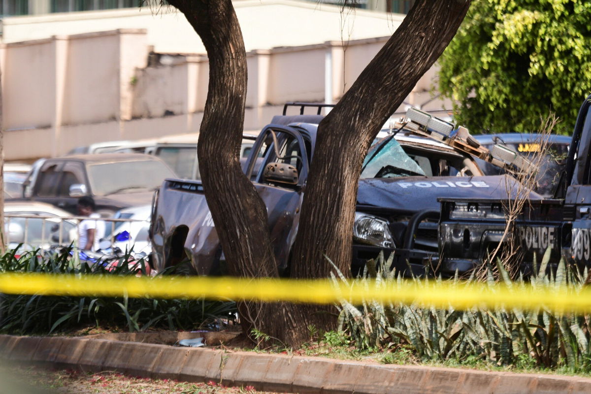 <i>Abubaker Lubowa/Reuters</i><br/>A general view shows wreckages of police vehicles at the scene of a blast in Kampala