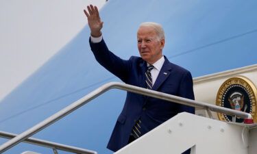 U.S. President Joe Biden waves as he boards Air Force One after attending the G20 summit in Rome