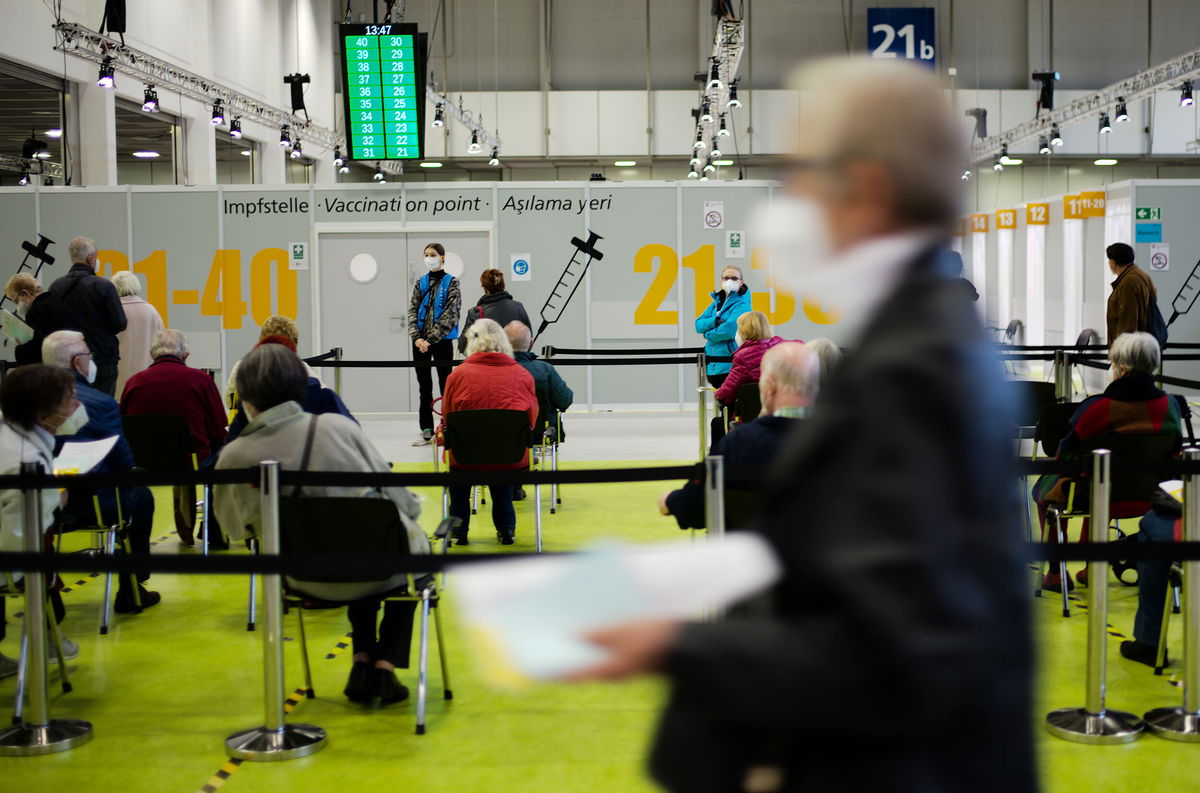 <i>Markus Schreiber/AP</i><br/>People wait to be vaccinated in Berlin