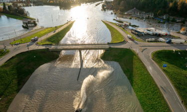 A boat goes under an overpass as it speeds along a flooded highway in Abbotsford