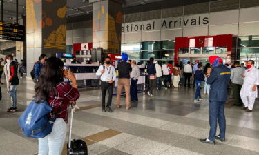 People wait for their relatives and friends to come out of the Indira Gandhi International airport