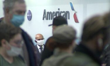 People wait in line at an American Airlines counter at an airport in Charlotte