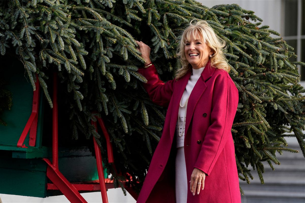 <i>Patrick Semansky/AP</i><br/>First lady Jill Biden receives the official 2021 White House Christmas tree at the White House on Nov. 22