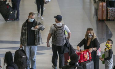 Holiday travelers pass through Los Angeles International Airport in November of 2020. Air travel is expected to be up 80% for Thanksgiving this year.