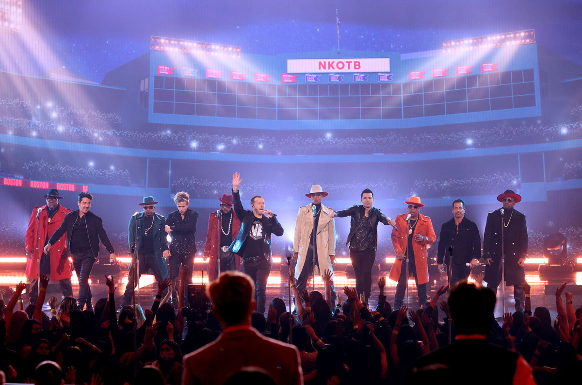 <i>Kevin Winter/Getty Images for MRC</i><br/>Members of New Edition and New Kids On The Block perform onstage during the 2021 American Music Awards at Microsoft Theater on November 21