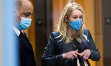 Theranos founder Elizabeth Holmes collects her belongings after arriving to attend her fraud trial at federal court in San Jose