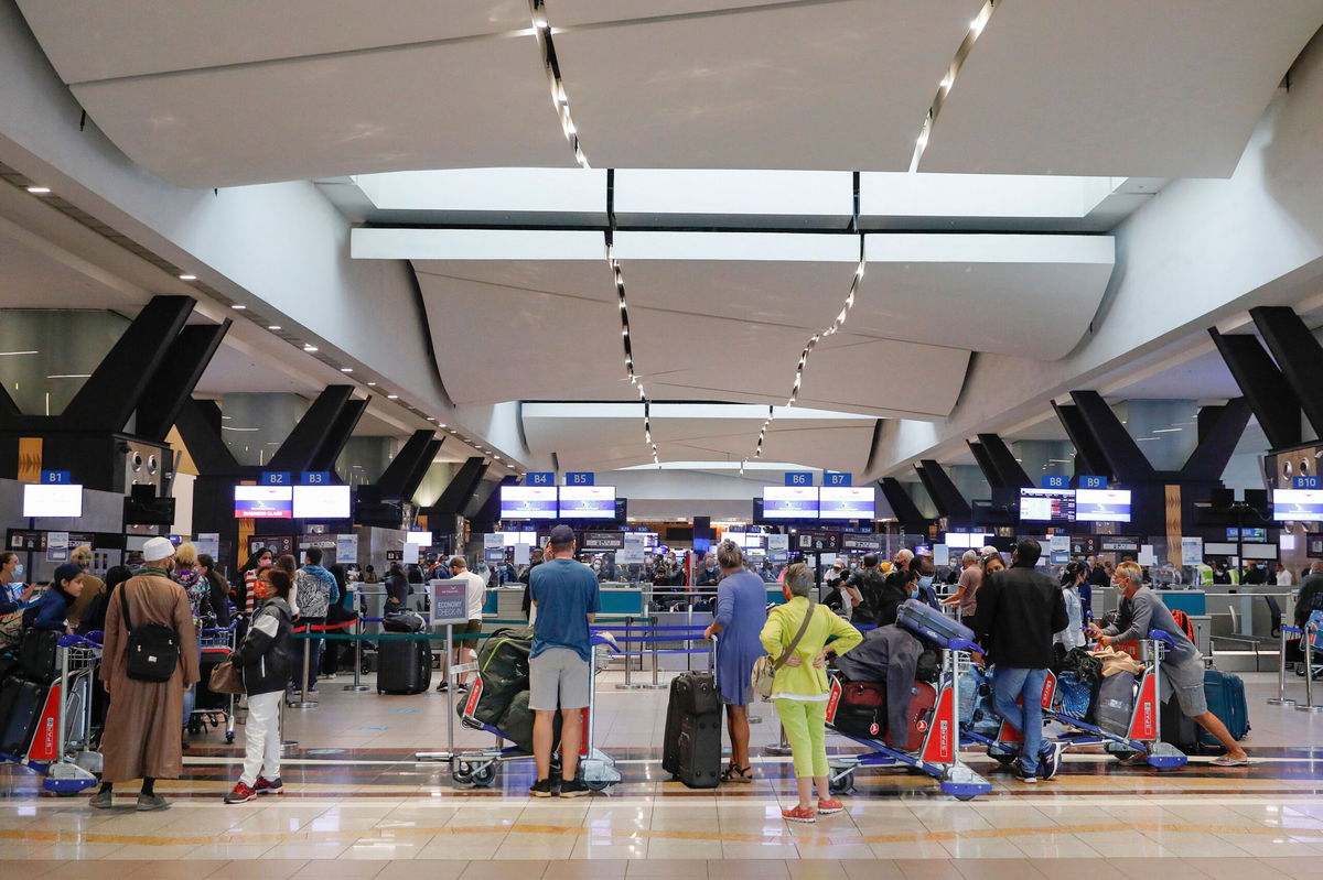 <i>Phill Magakoe/AFP/Getty Images</i><br/>Travelers queue at a check-in counter at OR Tambo International Airport in Johannesburg on November 27