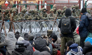 Migrants from the Middle East and elsewhere gather at the checkpoint "Kuznitsa" at the Belarus-Poland border near Grodno