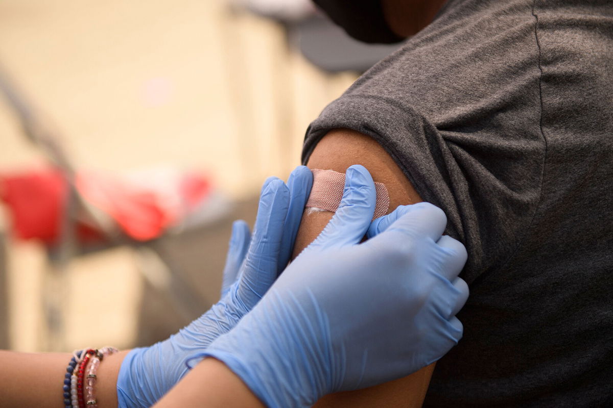 <i>Patrick T. Fallon/AFP/Getty Images</i><br/>Millions of child-size doses of Pfizer's Covid-19 vaccine are being shipped from the company's facilities to distribution centers across the country. A person receives their first dose of the Pfizer Covid-19 vaccine in Los Angeles