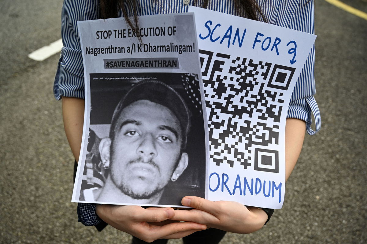 <i>Mohd Rasfan/AFP/Getty Images</i><br/>An activist holds a placard before submitting a memorandum to parliament in protest at the impending execution of Nagaenthran K. Dharmalingam
