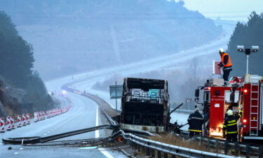 Firefighters and forensic workers inspect the scene of a bus crash which