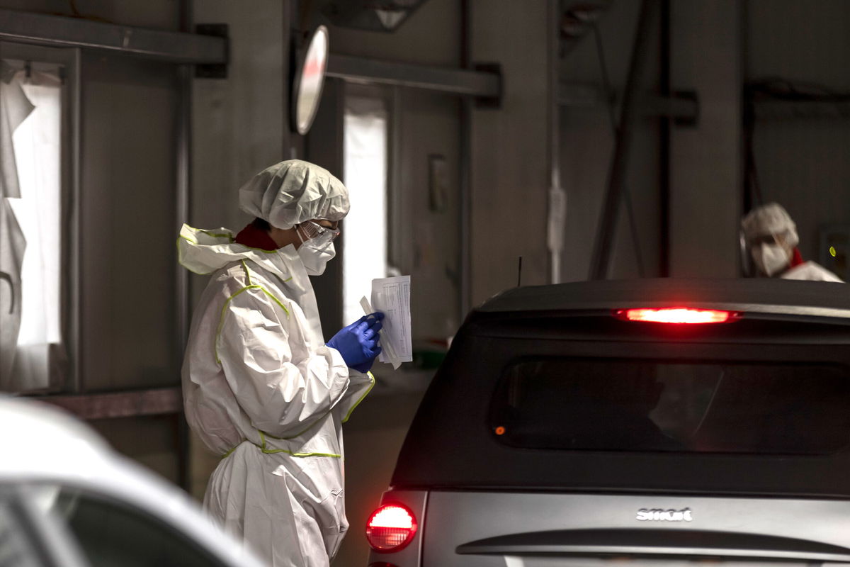 <i>Jan Hetfleisch/Getty Images</i><br/>A health worker collects swab sample from a person at a COVID-19 testing station on November 08 in Innsbruck