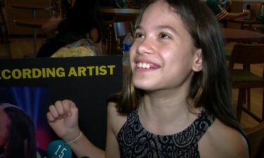 10-year-old Isabella Velasquez smiles as she talks about her rendition of the national anthem before the December 19 National Football League game between the New York Jets and Miami Dolphins at Miami's Hard Rock Stadium.