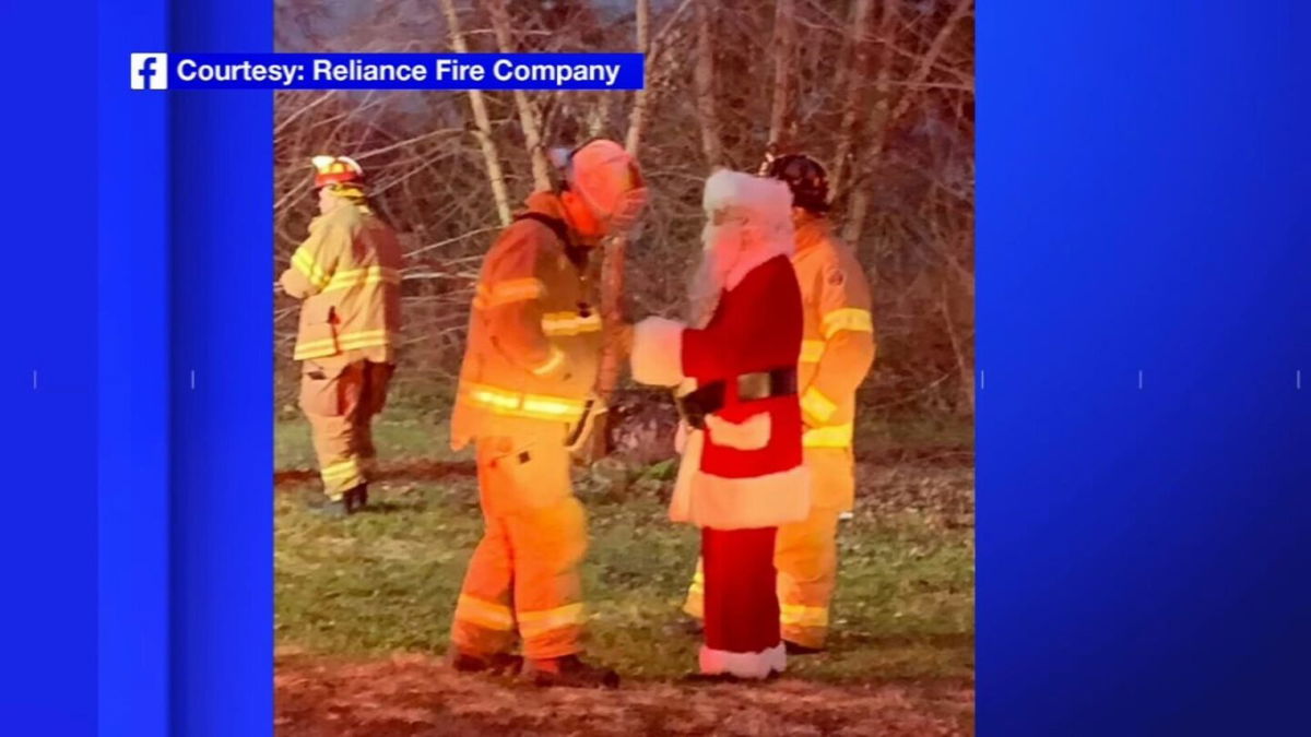 <i>WABC/Reliance Fire Company</i><br/>Santa Clause chats with members of the Reliance Fire Company on December 18. Santa was riding in a fire truck when he noticed fire coming from the edge of the roof of a three-story home and helped firefighters alert a family to the blaze.