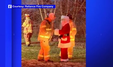 Santa Clause chats with members of the Reliance Fire Company on December 18. Santa was riding in a fire truck when he noticed fire coming from the edge of the roof of a three-story home and helped firefighters alert a family to the blaze.