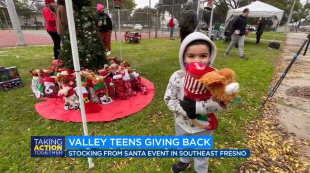 <i>KFSN</i><br/>A young child holds a stocking stuffed with goodies at an event sponsored by Friends.giving