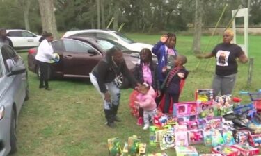 A Theodore woman held a toy giveaway Tuesday to honor the memory of her late husband.